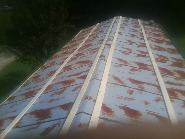 Rusted metal roof panels with new wood purlins before replacement — Storm Damage Roof Repair in Sandy Hook by Roofing Brothers